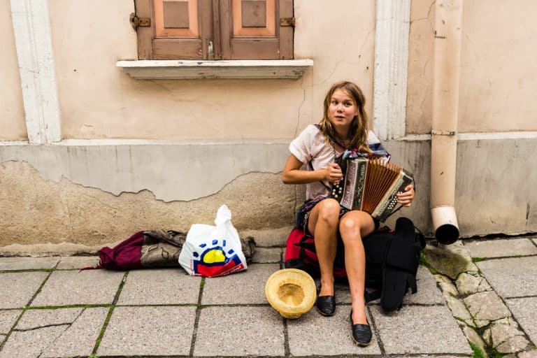 female beg packer playing music