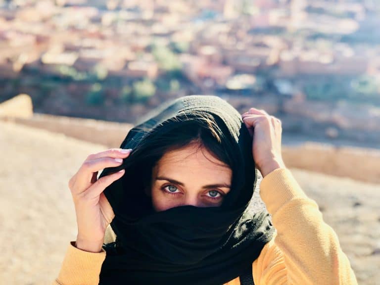 Female in a black hijab in a desert
