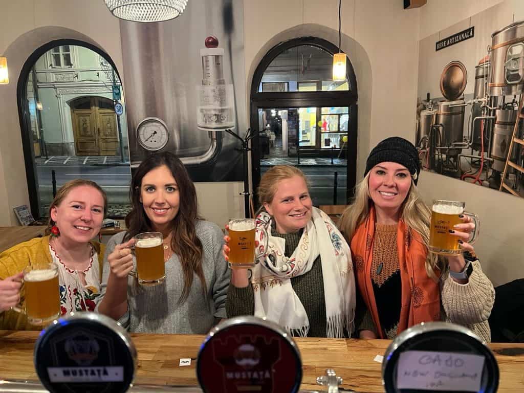 solo female travelers in Romania drinking beer at a pub