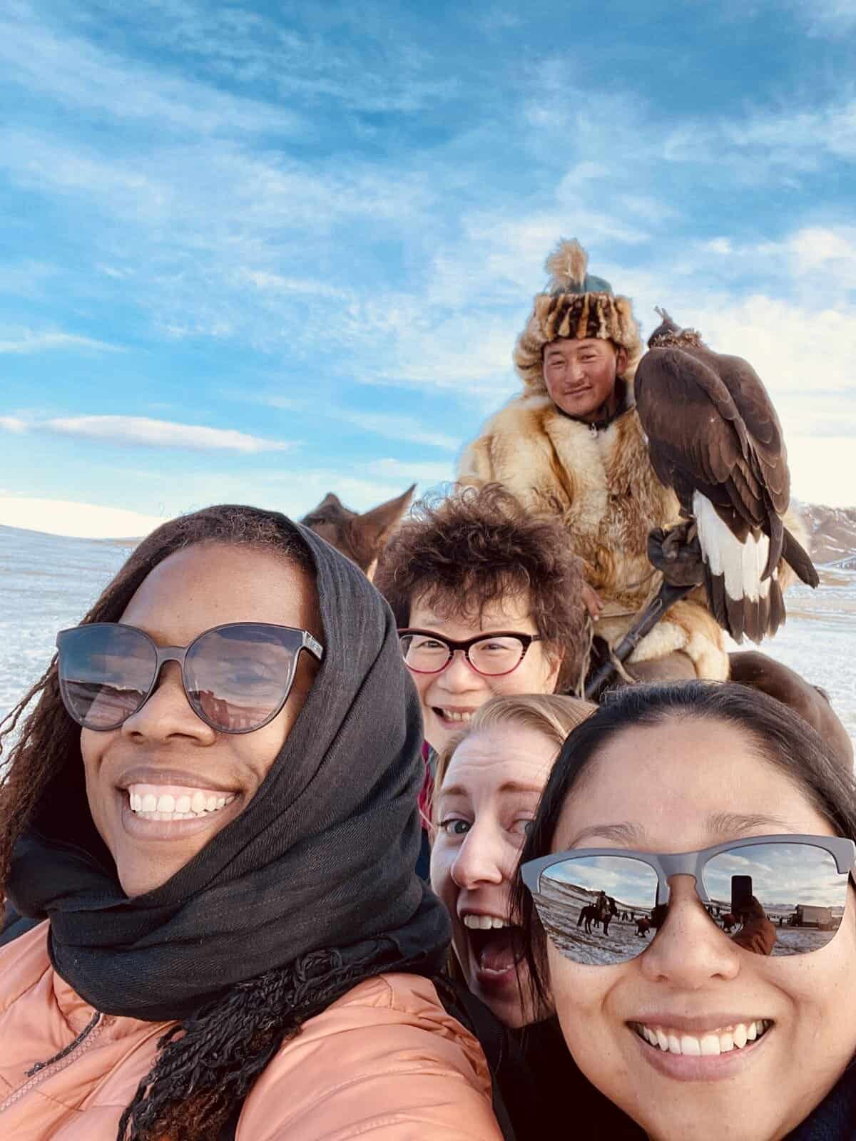 solo female travel tour to Mongolia selfie with man holding an eagle