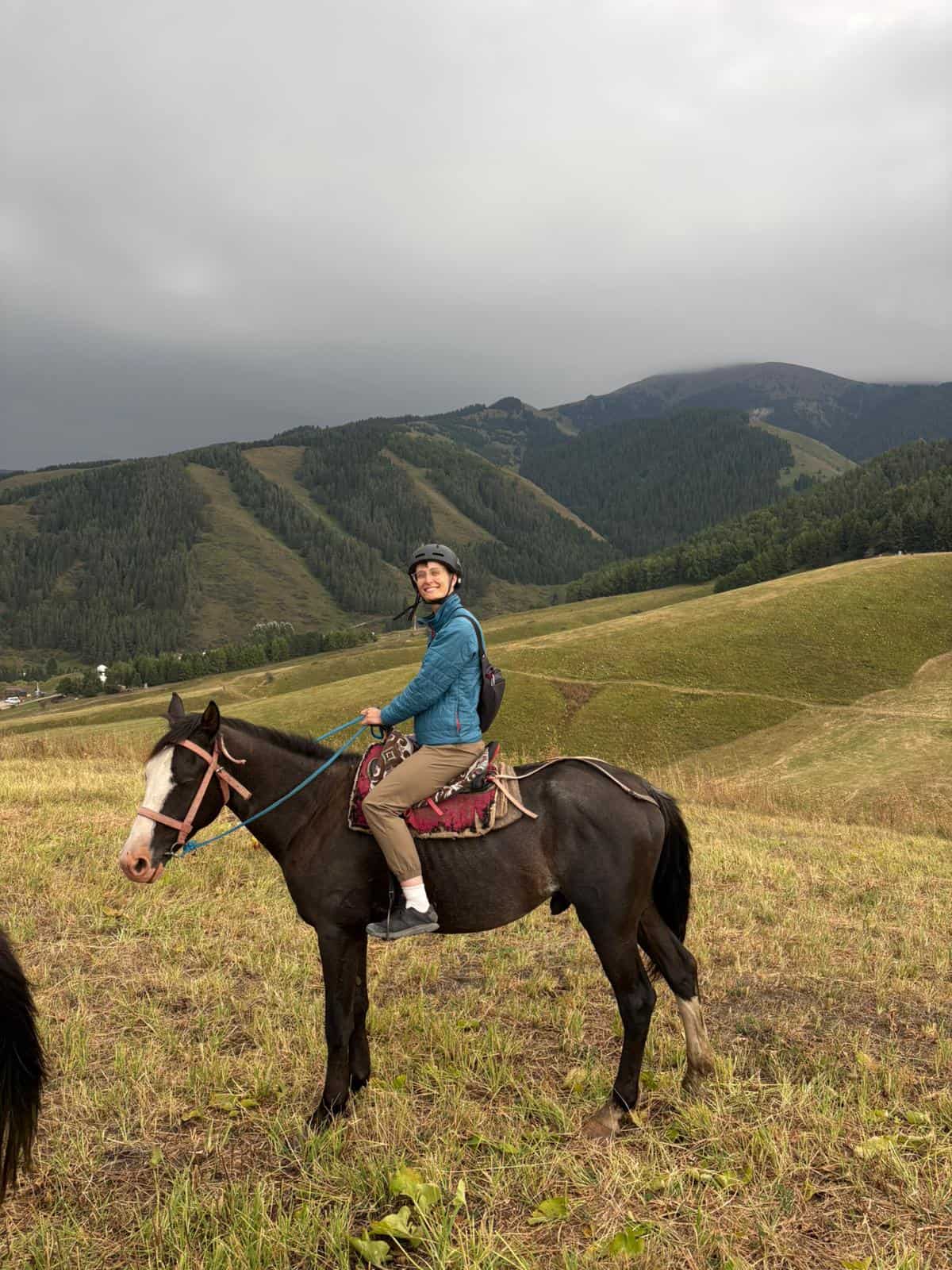 A SoFe traveler on horseback in the mountains of Kyrgyzstan