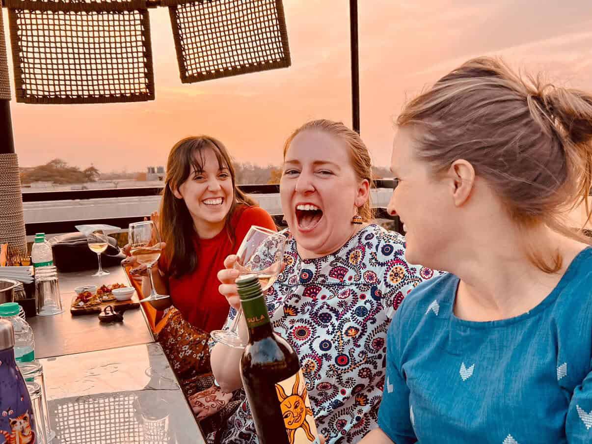 SoFe travelers sharing sunset drinks on a rooftop in India