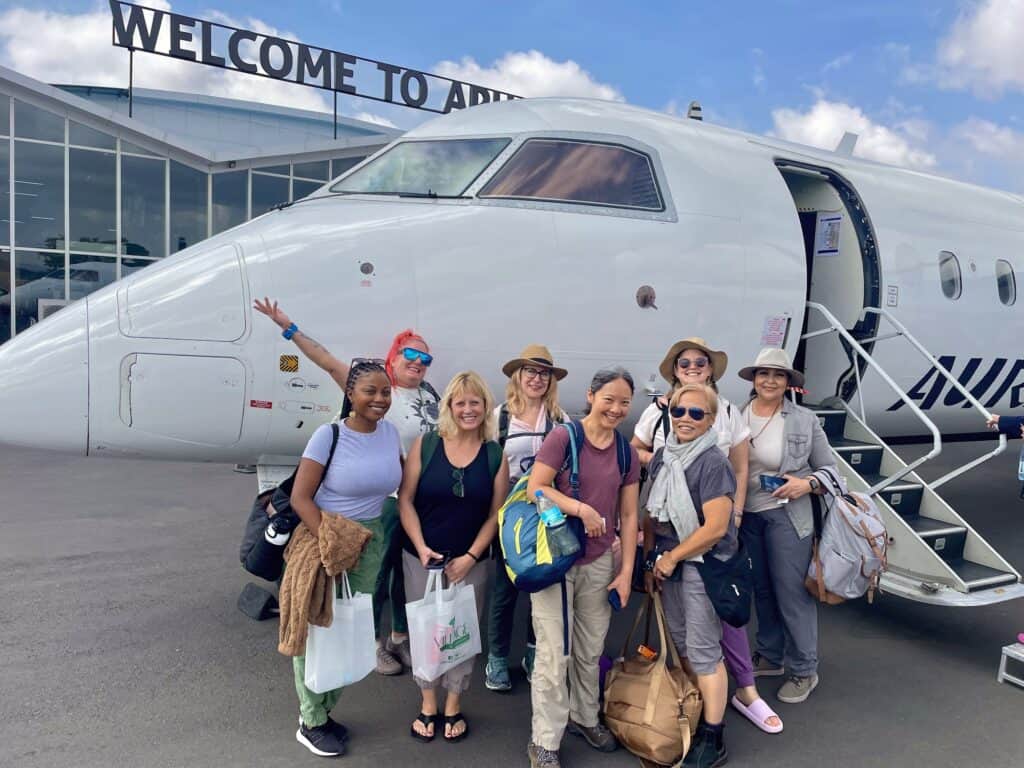 SoFe travelers in front of their plane at the airport in Arusha, Tanzania
