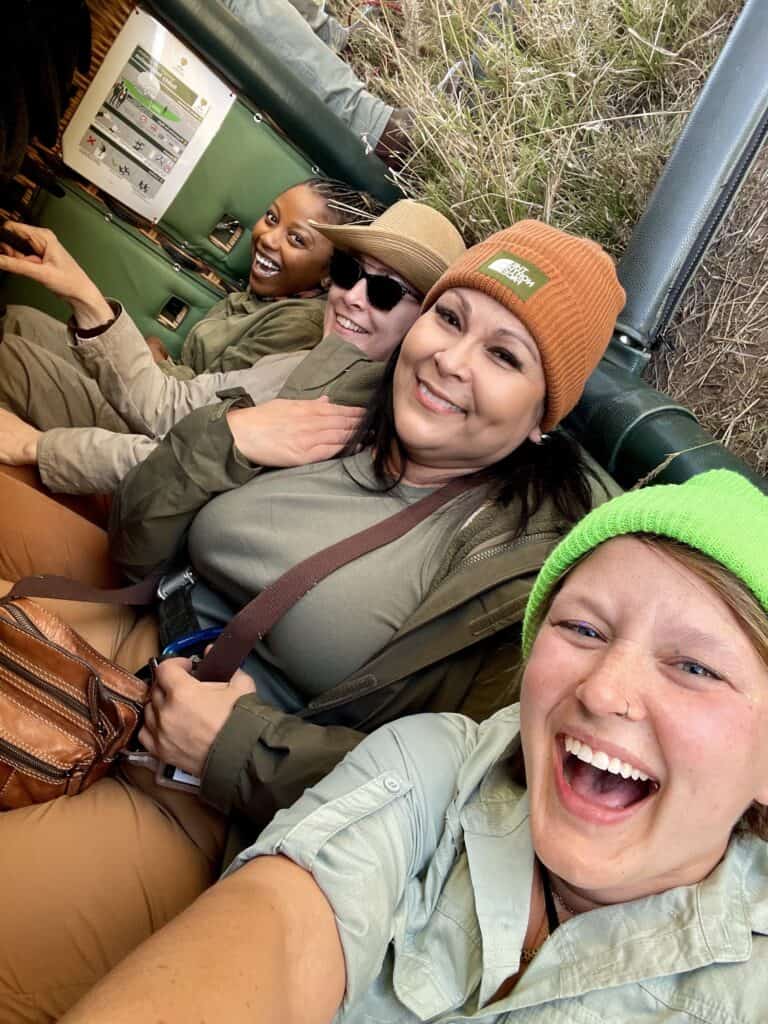 Chelsea and new friends laughing in a safari truck in Tanzania