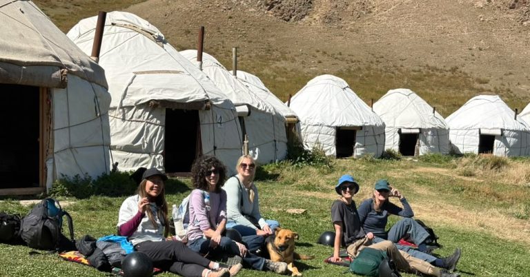 Kyrgyzstan group photo outside yurts