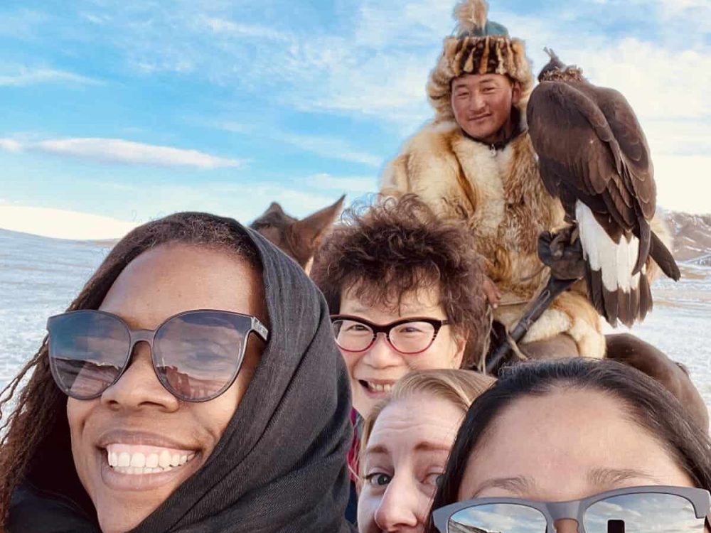 solo female travel tour to Mongolia selfie with man holding an eagle