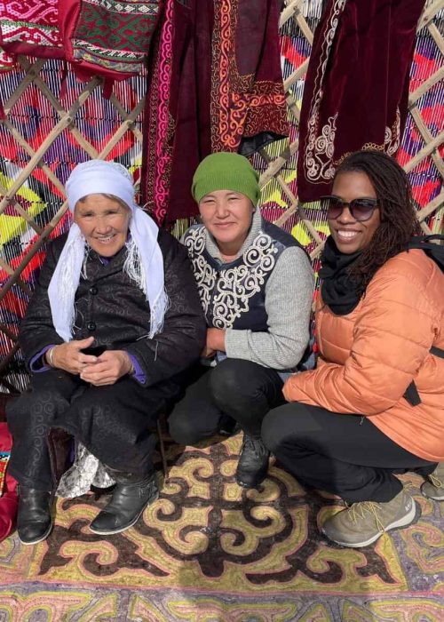 women on an all women tour smiling with eagle hunters in Mongolia